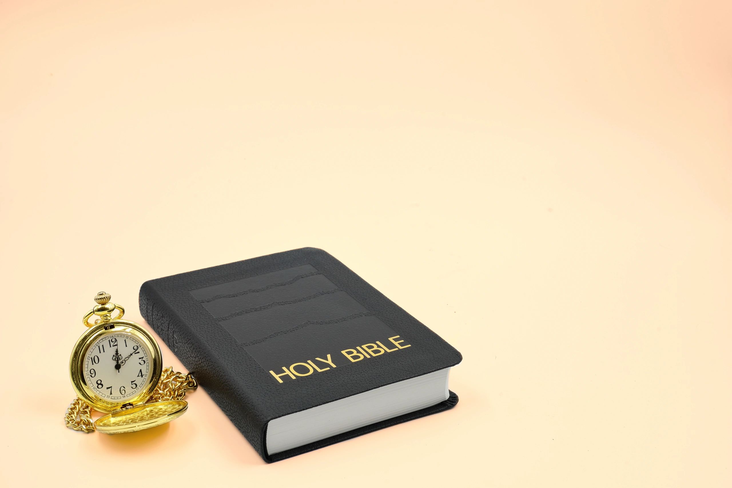 Holy Bible with pocket watch symbolizing timeless truth